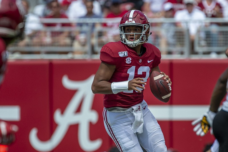 AP photo by Vasha Hunt / Alabama quarterback Tua Tagovailoa rolls out during a home game against Southern Miss on Sept. 21.