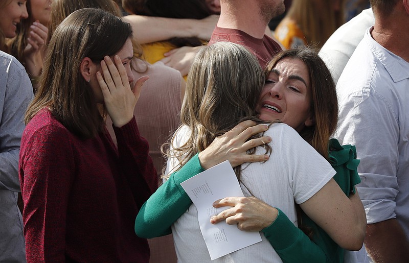 People attend the funeral of Dawna Ray Langford, 43, and her sons Trevor, 11, and Rogan, 2, who were killed by drug cartel gunmen, at the cemetery in La Mora, Sonora state, Mexico, Thursday, Nov. 7, 2019. Three women and six of their children, all members of the extended LeBaron family, died when they were gunned down in an attack while traveling along Mexico's Chihuahua and Sonora state border on Monday. (AP Photo/Marco Ugarte)