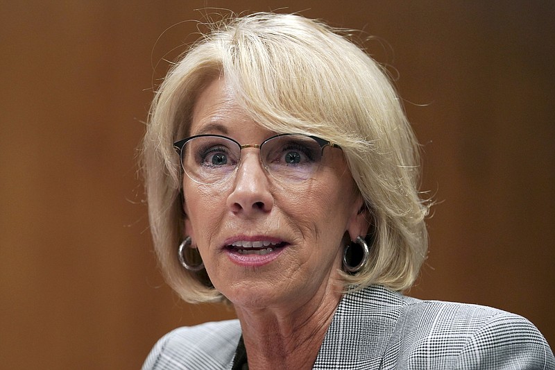 FILE - In this June 5, 2018, file photo, Education Secretary Betsy DeVos testifies during a Senate Subcommittee on Labor, Health and Human Services, Education, and Related Agencies Appropriations in Washington. Facing a federal lawsuit and mounting pressure to act, Education Secretary Betsy DeVos on Friday, Nov. 8, 2019, said she will forgive loans for more than 1,500 borrowers who attended a pair of for-profit colleges that shut down last year. (AP Photo/Carolyn Kaster, File)