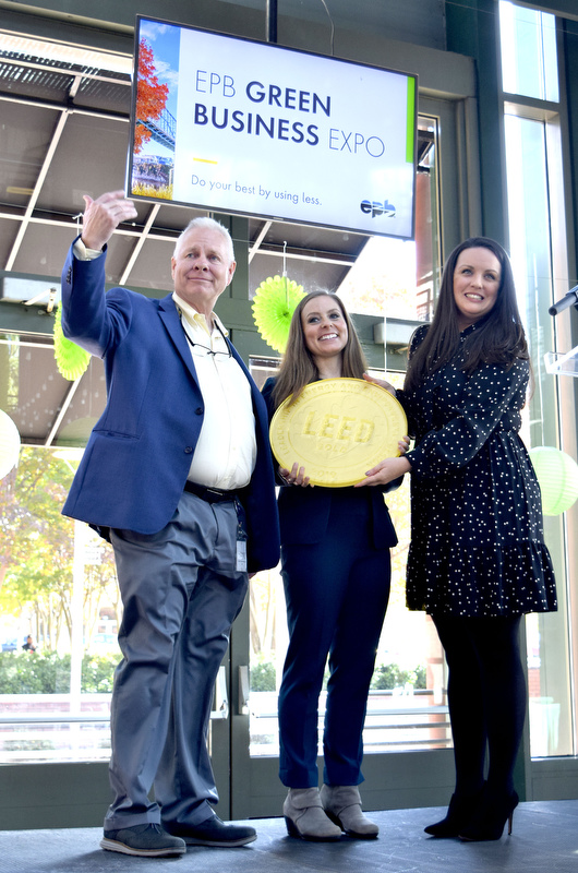 Staff Photo by Robin Rudd/ EPB President & CEO Dan Wade motions for more EPB employees to join in a photo while Elizabeth Hammitt Director of Environmental Stewardship & Community at EPB and Rhiannon Jacobsen, VP, Market Transformation & Development at the US Green Building Council hold the LEED plague. During the EPB Green Expo, at Miller Plaza's Waterhouse Pavilion, it was announced that the EPB building will be one of the first LEED Gold buildings in Chattanooga. The Expo took place on November 8, 2019.