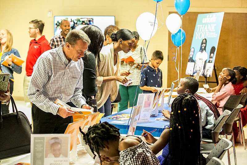 Contributed photo by Flint Chaney / Students from Boys & Girls Clubs of Chattanooga's "Literacy Up! The Write Way" program sign copies of their books for attendees at their book-signing held recently at the Highland Park clubhouse.