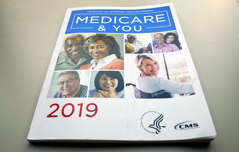 FILE - In this Nov. 8, 2018, file photo, the U.S. Medicare Handbook is photographed, in Washington. A new study finds that more than half of seriously ill Medicare enrollees _ 53% _ struggle to pay their medical bills. Prescription drugs are the leading problem. The researchers who wrote Monday’s report in the journal Health Affairs were surprised by their findings, since Medicare is considered relatively good coverage.  (AP Photo/Pablo Martinez Monsivais, File)