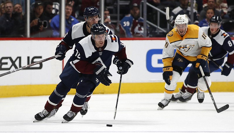 Colorado Avalanche right wing Joonas Donskoi, front, drives down the ice with the puck with left wing Andre Burakovsky, back left, and Nashville Predators center Colton Sissons trailing during the third period of an NHL hockey game Thursday, Nov. 7, 2019, in Denver. Colorado won 9-4. (AP Photo/David Zalubowski)