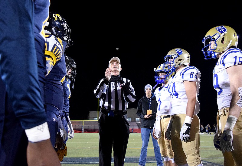 Staff photo by Robin Rudd / The referee tosses the coin in front of the captains before Friday night's Division II-AA playoff game between Christian Academy of Knoxville and host Chattanooga Christian School.