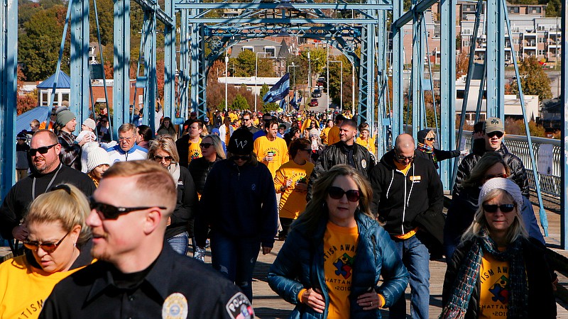 Staff photo by C.B. Schmelter / The 7th Annual Chattanooga Autism Awareness Walk makes its way across the Walnut Street Bridge on Saturday, Nov. 9, 2019 in Chattanooga, Tenn. The event included hands-on activities, vendor tables, live music and the walk which began in Coolidge Park.