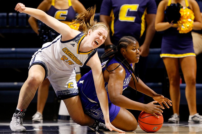 Staff photo by C.B. Schmelter / UTC's Abbey Cornelius, left, gets tangled up with Hampton forward Nylah Young during Saturday's game at McKenzie Arena.