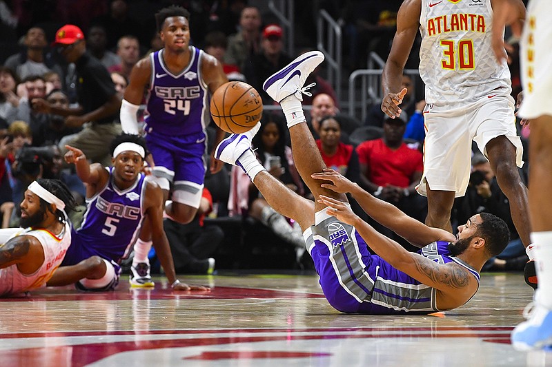 AP photo by John Amis / Sacramento Kings guard Cory Joseph passes while on his back during the second half of Friday night's game in Atlanta. The Kings beat the Hawks 121-109.