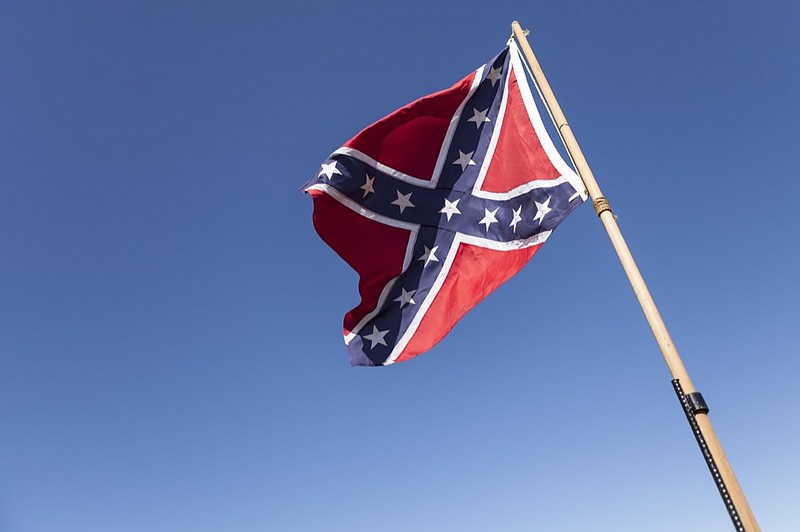 Confederate Flag on pole over blue sky. civil war tile confederate flag tile / Getty Images
