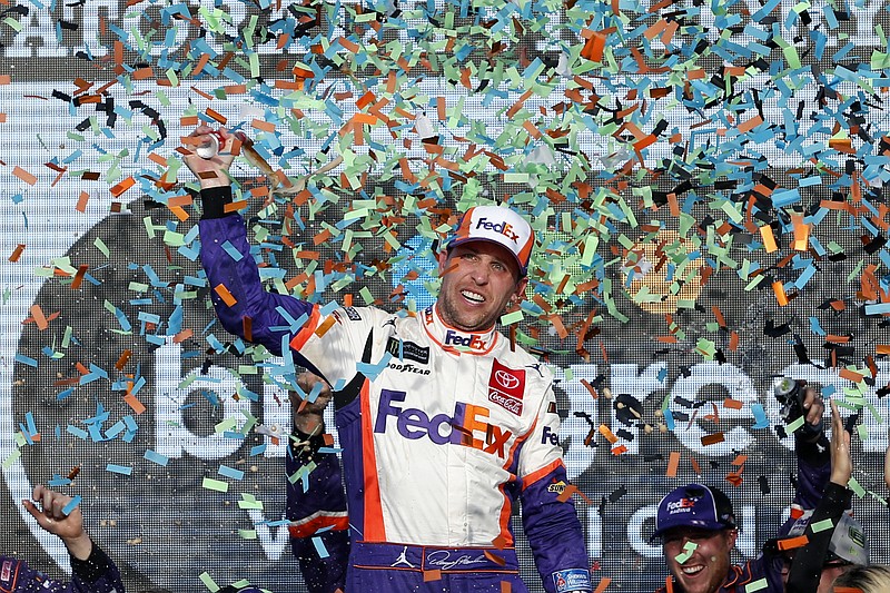 AP photo by Ralph Freso / Denny Hamlin celebrates in victory lane at ISM Raceway after winning Sunday's NASCAR Cup Series race at the track in Avondale, Ariz. Hamlin will be joined by Joe Gibbs Racing teammates Kyle Busch and Martin Truex Jr. as well as Stewart-Haas Racing's Kevin Harvick in contending for the series championship next Sunday in the season finale at Homestead-Miami Speedway.