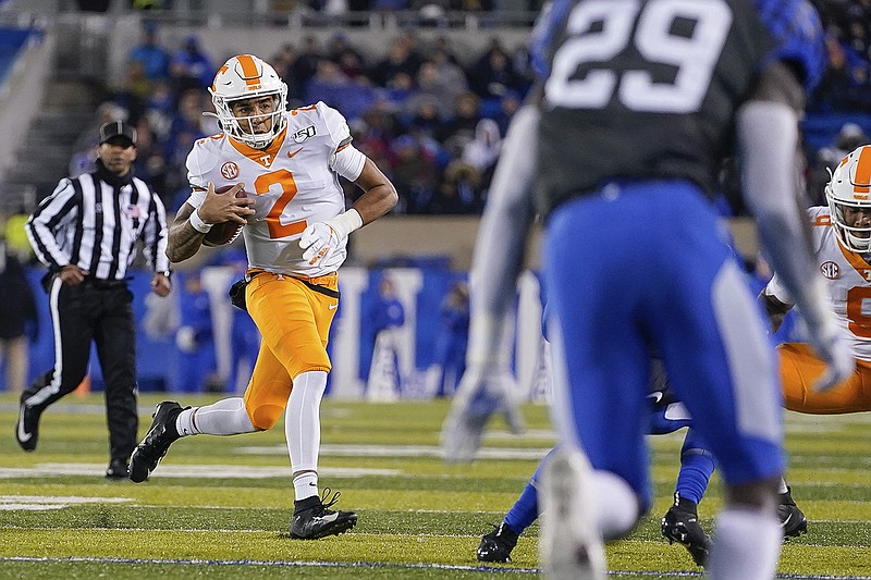 AP photo by Bryan Woolston / Tennessee quarterback Jarrett Guarantano carries the ball during the second half of Saturday night's game at Kentucky.