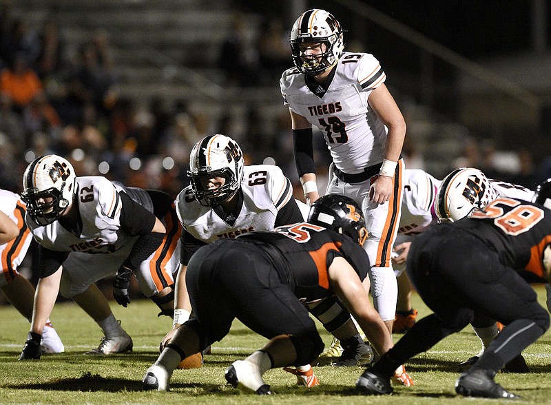 Staff Photo by Robin Rudd/  Quarterback Aaron Swafford (19) sets the Meigs offense.  The Meigs County Tigers visited the South Pittsburg Pirates in TSSAA football action on October 11, 2019.