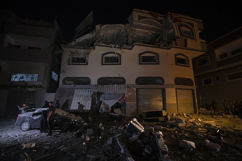 Palestinians check the damage of a house targeted by Israeli missile strikes in Gaza City, Tuesday, Nov. 12, 2019. The Israeli military says it has struck a Gaza City house, targeting a commander from the Islamic Jihad group in a resumption of pinpointed killing. The Iranian-backed Palestinian group confirmed Tuesday that Bahaa Abu el-Atta, it's north Gaza Strip commander, was killed. (AP Photo/Khalil Hamra)