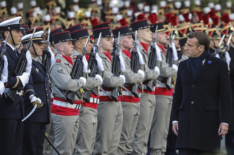 French President Emmanuel Macron reviews the troops as he inaugurates a memorial for soldiers fallen in foreign conflicts, Monday Nov. 11, 2019 in Paris. As part of commemorations marking 101 years since World War I's Armistice, French President Emmanuel Macron led a ceremony for the 549 French soldiers who died in 17 theaters of conflict since the 60s. (Ludovic Marin/Pool via AP)