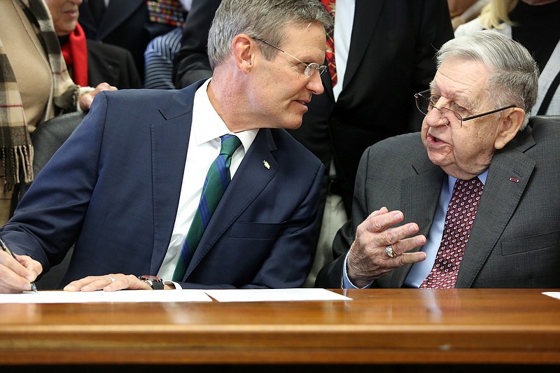 Staff photo by Erin O. Smith / Tennessee Governor Bill Lee signs a Senate bill while speaking with retired U.S. Army Brig. Gen. Carl Levi that formally renames what was formerly CSM Bobby G. Davis armory to the CSM Bobby G. Davis and BG Carl E. Levi Armory at the National Guard Armory Wednesday, November 13, 2019 in Chattanooga, Tennessee. The event was held to honor Levi by dedicating Chattanoogaճ National Guard Armory to the 88-year-old veteran and civil servant.