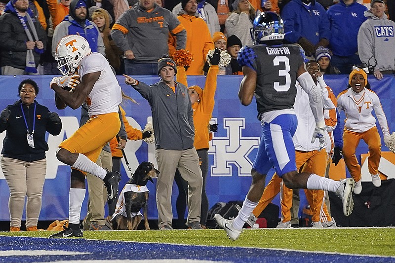 AP photo by Bryan Woolston / Tennessee wide receiver Josh Palmer, left, scores a touchdown during the second half of the Vols' 17-13 win last Saturday night at Kentucky.