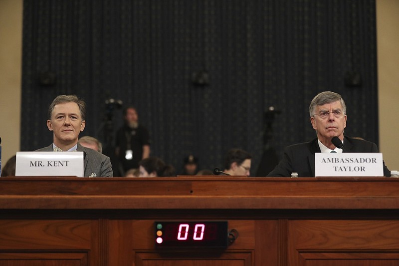 Top U.S. diplomat in Ukraine William Taylor, right, and career Foreign Service officer George Kent, take their seats as they arrive to testify before the House Intelligence Committee on Capitol Hill in Washington, Wednesday, Nov. 13, 2019, during the first public impeachment hearing of President Donald Trump's efforts to tie U.S. aid for Ukraine to investigations of his political opponents. (AP Photo/Andrew Harnik)