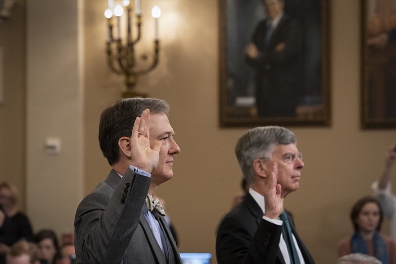 Career Foreign Service officer George Kent, left, and top U.S. diplomat in Ukraine William Taylor, right, are sworn in to testify before the House Intelligence Committee on Capitol Hill in Washington, Wednesday, Nov. 13, 2019, during the first public impeachment hearings on President Donald Trump's efforts to tie U.S. aid for Ukraine to investigations of his political opponents. (AP Photo/(AP Photo/J. Scott Applewhite)