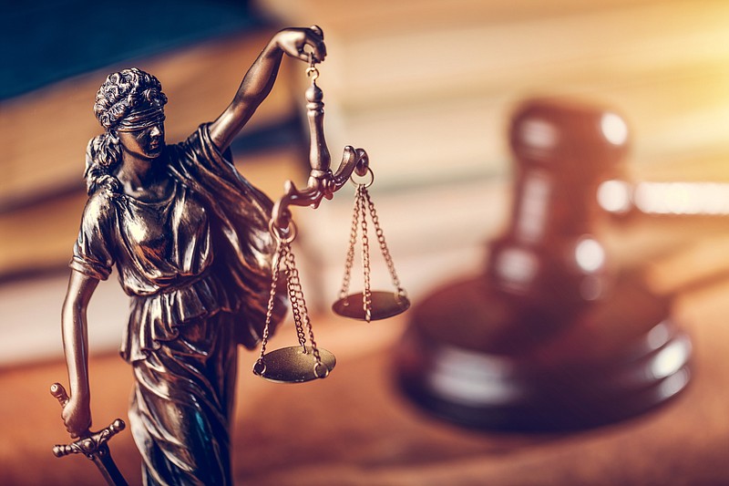 Law concept - Themis statue, judge hammer and books. / Getty Images/iStockphoto/NiseriN