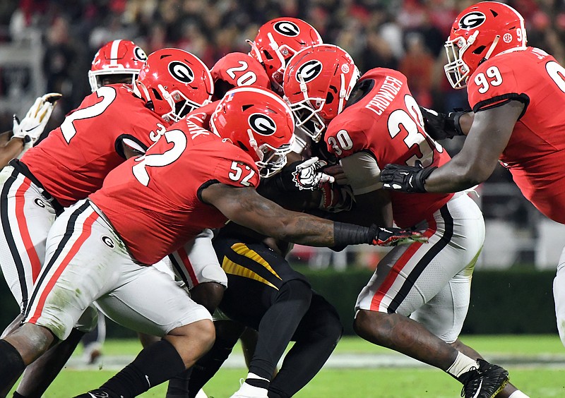 Georgia photo by Perry McIntyre / Georgia defenders Monty Rice, left, Tyler Clark (52), J.R. Reed (20), Tae Crowder (30) and Jordan Davis (99) swarm to the ball during last Saturday's 27-0 home win against Missouri.