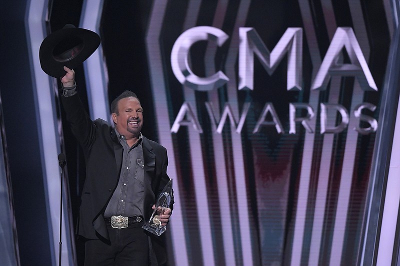 Garth Brooks accepts the award for entertainer of the year at the 53rd annual CMA Awards at Bridgestone Arena, Wednesday, Nov. 13, 2019, in Nashville, Tenn. (AP Photo/Mark J. Terrill)