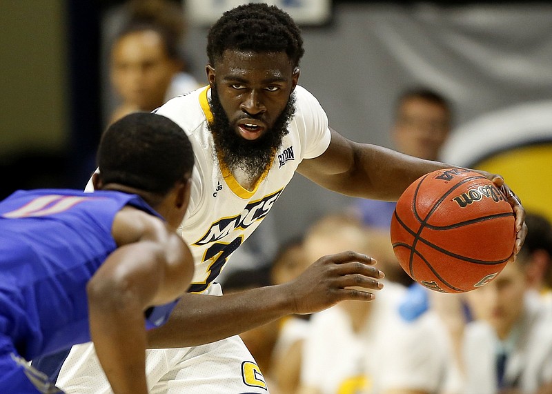 Staff file photo by C.B. Schmelter / UTC's David Jean-Baptiste handles the ball while guarded by Tennessee State's Mark Freeman on Nov. 9 at McKenzie Arena. Jean-Baptiste had a big game for the Mocs on Friday night, scoring 25 points as they beat South Alabama 90-72.