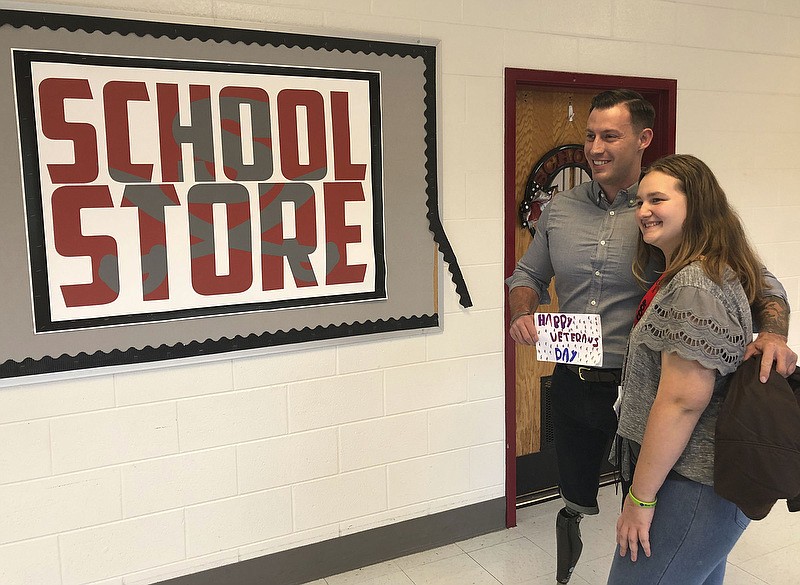 Staff Photo by Patrick Filbin/  Joey Jones poses with a Southeast Whitfield High School student who stopped him in the hall Tuesday morning to give him a handwritten Veterans Day card she made for him. 