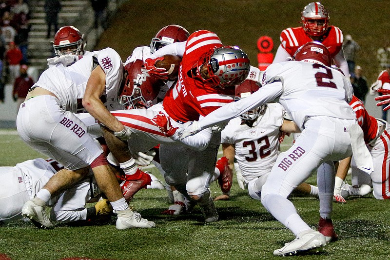 Staff photo by C.B. Schmelter / MBA's Dominic Allocco, left, Jake Stumb, rear, and Nasir Cook (2) stop Baylor's Elijah Howard inside the 8-yard line on fourth down and short of the first-down marker during a Division II-AAA quarterfinal Friday night at Baylor's Heywood Stadium.