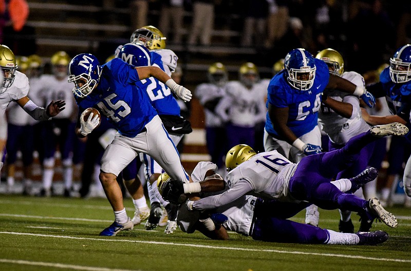 Photo by Cade Deakin / McCallie's Gavin Cagle attempts to break a tackle against Christian Brothers in a Division II-AAA state quarterfinal Friday night at McCallie's Spears Stadium. Cagle scored two touchdowns in a 28-6 win for the Blue Tornado.