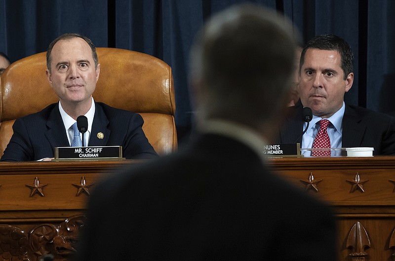House Intelligence Committee Chairman Rep. Adam Schiff, D-Calif., left, and ranking member Rep. Devin Nunes, R-Calif., watch as Top U.S. diplomat in Ukraine William Taylor leaves after testifying at a hearing of the House Intelligence Committee on Capitol Hill in Washington, Wednesday, Nov. 13, 2019, during the first public impeachment hearing of President Donald Trump's efforts to tie U.S. aid for Ukraine to investigations of his political opponents. (Saul Loeb/Pool Photo via AP)