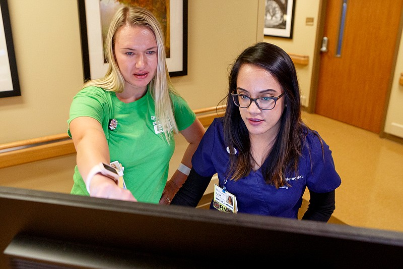 Staff photo illustration by C.B. Schmelter / In this photo illustration, nurses Yuliya Belova, left, and Rolla Dayrit use the newly installed Epic electronic health record system in the Clinical Decision Unit at CHI Memorial Hospital on Thursday, Nov. 14, 2019 in Chattanooga, Tenn. Belova is a "super user" on the software. She under went extra training to be able to help others with the system.