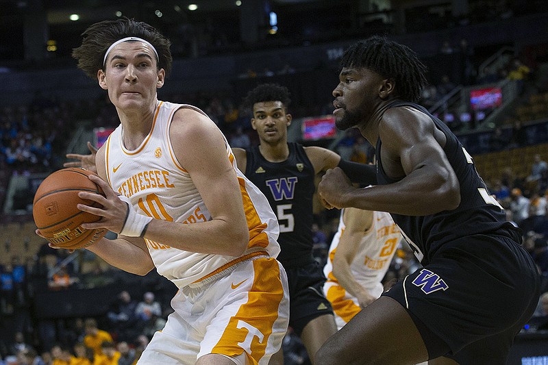 AP photo by Chris Young / Tennessee's John Fulkerson, left, shields the ball from Washington's Isaiah Stewart during the first half of Saturday's game at the James Naismith Classic in Toronto.