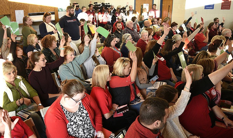 Staff Photo by Robin Rudd/   Many attendees hold up green cards to answer in the affirmative to a question raised at the town hall.  Hamilton County United held a teachers town hall at the Brainerd Youth and Family Development Center discussing the funding of public education and increasing teacher pay. November 17, 2019