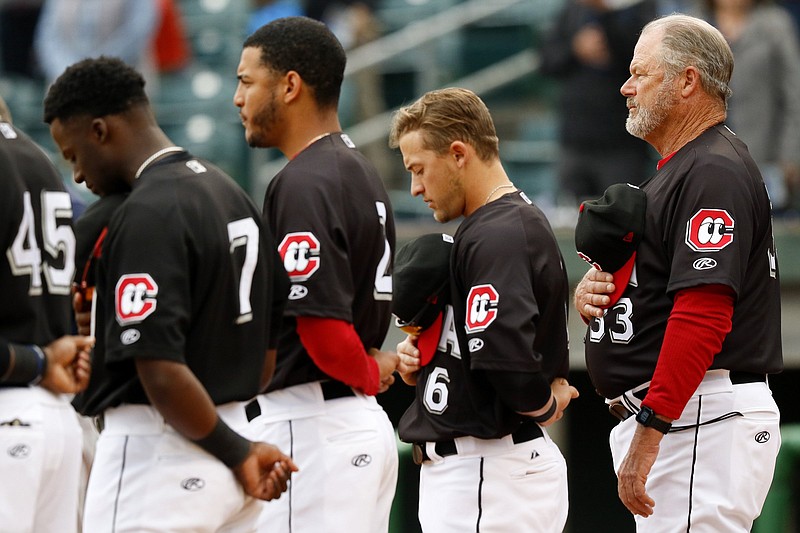 Staff photo by C.B. Schmelter / Manager Pat Kelly (33) and members of the Chattanooga Lookouts stand for the national anthem before taking on the Montgomery Biscuits on opening night at AT&T Field on Thursday, April 4, 2019 in Chattanooga, Tenn.