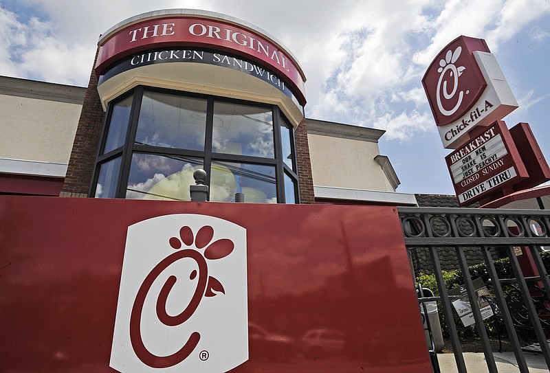 FILE - This July 19, 2012, file photo shows a Chick-fil-A fast food restaurant in Atlanta. Chick-fil-A is ending donations to three groups that oppose gay marriage in an effort to halt protests and broaden its customer base. But the move has angered some of the fast food chain’s fans. The Atlanta-based company said Monday, Nov. 18, 2019, that starting next year, it will focus its giving on three areas: hunger, homelessness and education. (AP Photo/Mike Stewart, File)