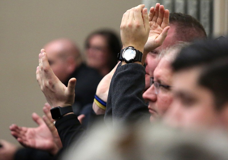 Staff photo by Erin O. Smith / Collegedale police officers clap after Rex Barton with the Municipal Technical Advisory Service states that the police department is well-run during the Collegedale Commission meeting at Collegedale City Hall Monday, November 18, 2019 in Collegedale, Tennessee. The Municipal Technical Advisory Service shared its independent assessment of the city's public works and police departments during the meeting.