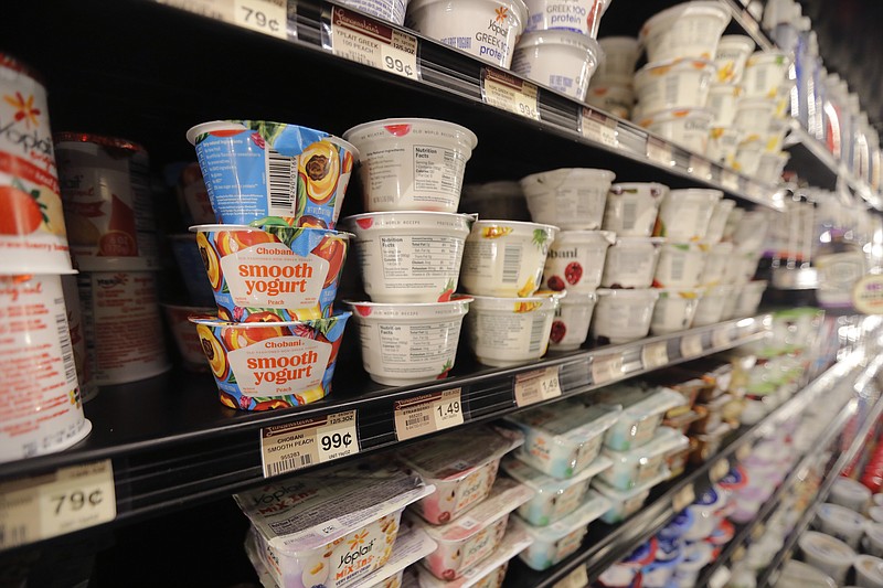 FILE - This July 11, 2018, file photo shows yogurt on display at a grocery store in River Ridge, La. Despite shelves full of new varieties, from Icelandic to Australian to coconut-based, U.S. yogurt sales are in a multiyear slump. Yogurt companies are confident that more new products can boost sales. But some analysts are skeptical, saying larger trends - like growing sales of breakfast protein bars - will be hard to turn around.  (AP Photo/Gerald Herbert, File-