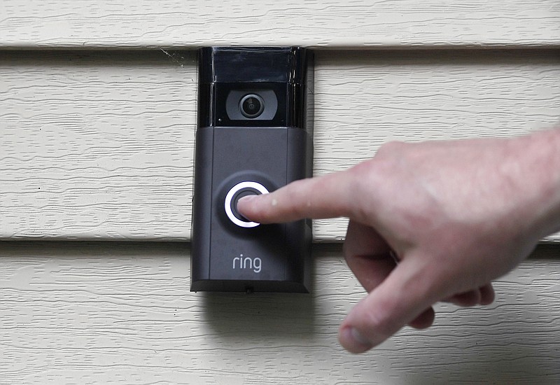 FILE - In this July 16, 2019, file photo, Ernie Field pushes the doorbell on his Ring doorbell camera at his home in Wolcott, Conn. Amazon says it has considered adding facial recognition technology to its Ring doorbell cameras. The company said in a letter released Tuesday, Nov. 19 by U.S. Sen. Ed Markey that facial recognition is a “contemplated, but unreleased feature” of its home security cameras. The Massachusetts Democrat wrote to Amazon CEO Jeff Bezos in September raising privacy and civil liberty concerns about Ring’s video-sharing partnerships with hundreds of police departments around the country.   (AP Photo/Jessica Hill, File)