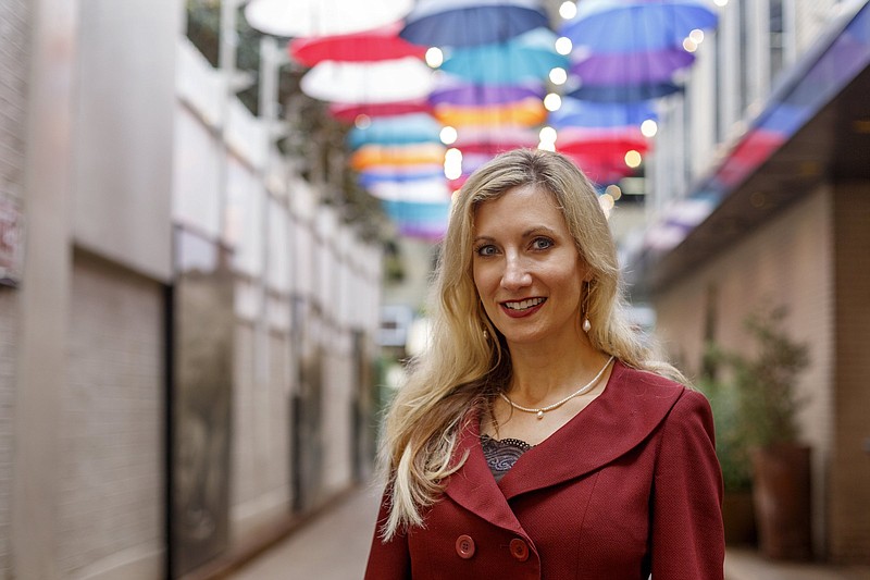 Staff photo by C.B. Schmelter / Chattanooga Area Chamber of Commerce President and CEO Christy Gillenwater poses in the alley behind the chamber offices.