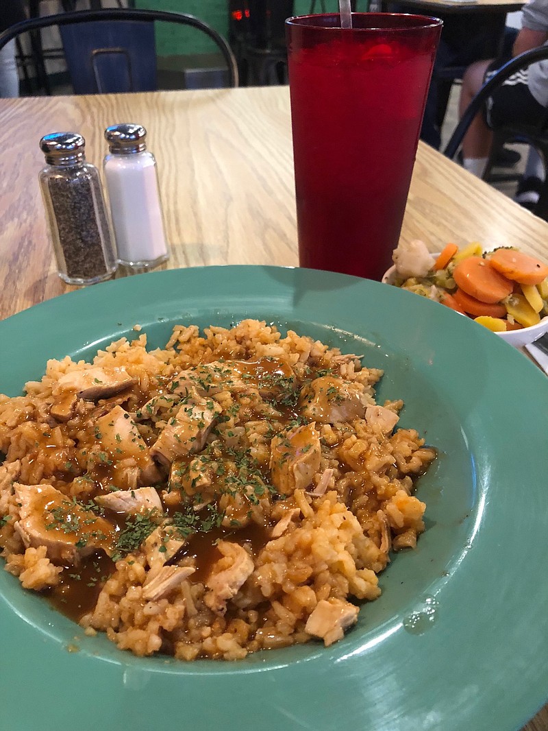 Photo by Susan Pierce / Mahoney's Chicken Marsala is a generous serving of rice topped with chicken medallions and chicken pieces that are drizzled in marsala sauce. The entree comes with one side.