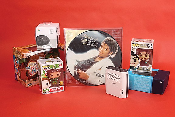 Staff photo by Erin O. Smith / Collectible, motorized Harry Potter quidditch stadium ($49.95), Google Home Mini ($17.95), Funko POP! Buddy Elf ($16.95), Michael Jackson "Thriller" album ($25.95), Bose SoundLink water-resistant Bluetooth speaker ($59.95), Funko POP! Witch ($7.95), Valve Steam Link Model 1003 game streaming device (24.95).