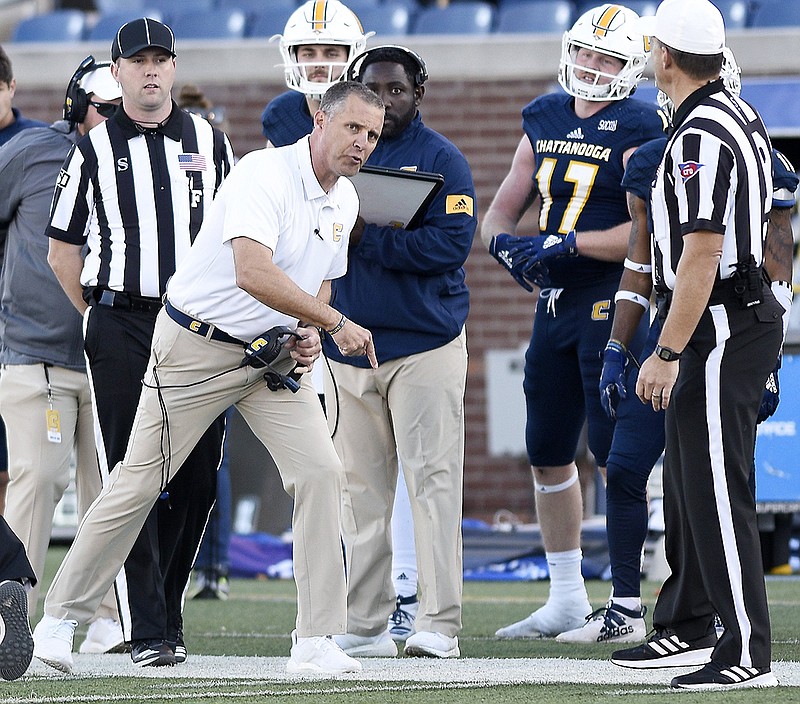 Staff photo by Robin Rudd / UTC football coach Rusty Wright shows his displeasure to referee Jeff Page during the Mocs' game against The Citadel last Saturday at Finley Stadium. The Mocs rallied for a 34-33 victory that kept them in the running for a share of the SoCon title going into their regular-season finale at VMI.