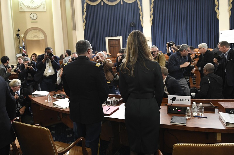 Jennifer Williams, right, an aide to Vice President Mike Pence, and National Security Council aide Lt. Col. Alexander Vindman, stand to take a break as they testify before the House Intelligence Committee on Capitol Hill in Washington, Tuesday, Nov. 19, 2019, during a public impeachment hearing of President Donald Trump's efforts to tie U.S. aid for Ukraine to investigations of his political opponents. (AP Photo/Susan Walsh)

