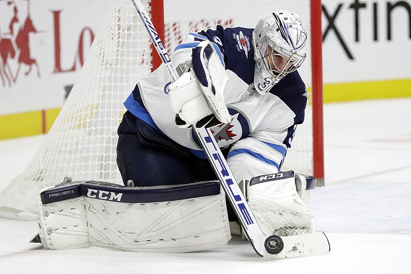 AP photo by Mark Humphrey / Winnipeg Jets goaltender Connor Hellebuyck stops a shot against the Nashville Predators in the second period of Tuesday night's Central Division matchup in Nashville.