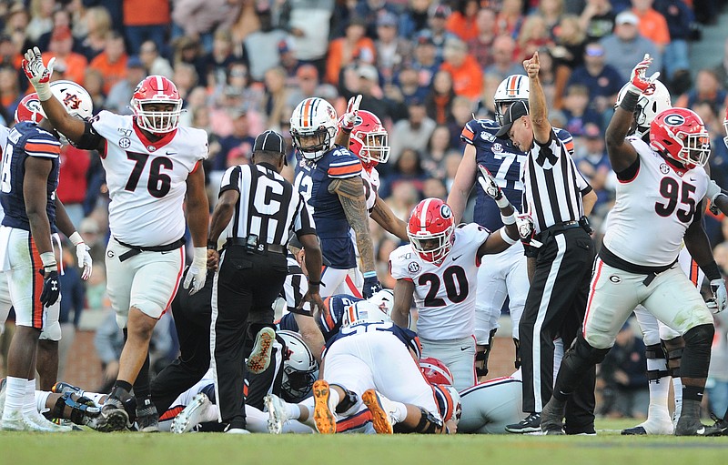 Georgia photo by Philip Williams / Georgia's defense celebrates a fumble recovery during last week's 21-14 triumph at Auburn. The Bulldogs have played four turnover-free games since committing four in their double-overtime loss to South Carolina on Oct. 12.