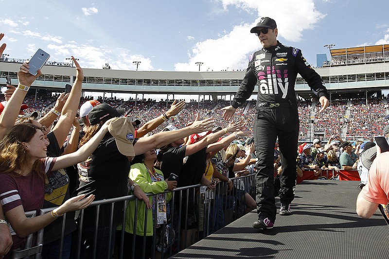 AP photo by Ralph Freso / Jimmie Johnson greets NASCAR fans during driver introductions before a Cup Series race Nov. 10 at ISM Raceway in the Phoenix area.