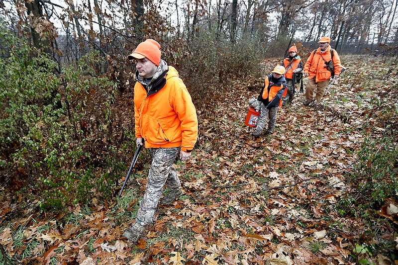 AP photo by Keith Srakocic / Dominick Cerminaro, left, leads his sons, Paul, center left, Santo, center right, and his father, Santo Cerminaro, right, into the woods to go deer hunting in November 2018. Friends and family are a big part of what makes a deer hunting camp special, writes outdoors columnist Larry Case.