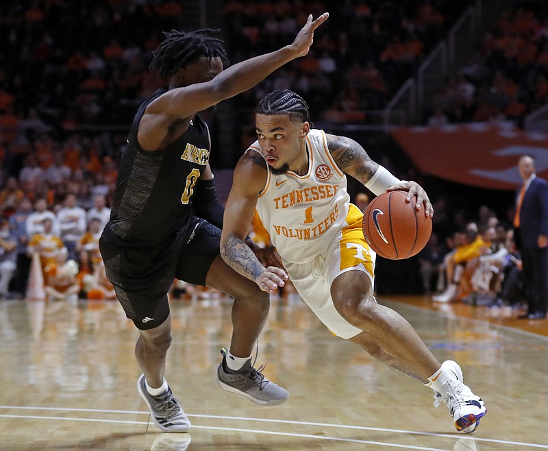 AP photo by Wade Payne / Tennessee guard Lamonte Turner drives past Alabama State's D.J. Heath during the first half of Wednesday night's game at Thompson-Boling Arena in Knoxville. Turner scored 13 points and reached 1,000 for his Vols career as the team rolled to a 76-41 win.