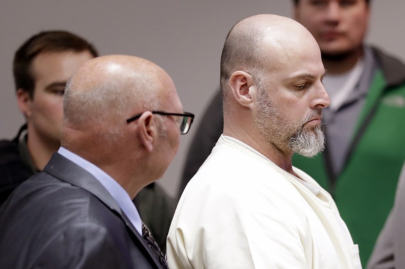 Curtis Watson, right, stands as a preliminary hearing is recessed Wednesday, Nov. 20, 2019, in Ripley, Tenn. Watson is charged with murdering Tennessee Department of Correction department administrator Debra Johnson after Watson escaped from the West Tennessee State Penitentiary in August. (AP Photo/Mark Humphrey, Pool)