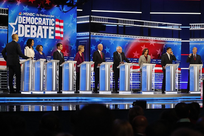 Democratic presidential candidates from left, Sen. Cory Booker, D-N.J., Rep. Tulsi Gabbard, D-Hawaii, Sen. Amy Klobuchar, D-Minn., South Bend, Ind., Mayor Pete Buttigieg, Sen. Elizabeth Warren, D-Mass., former Vice President Joe Biden, Sen. Bernie Sanders, I-Vt., Sen. Kamala Harris, D-Calif., former technology executive Andrew Yang and investor Tom Steyer participate in a Democratic presidential primary debate, Wednesday, Nov. 20, 2019, in Atlanta. (AP Photo/John Bazemore)