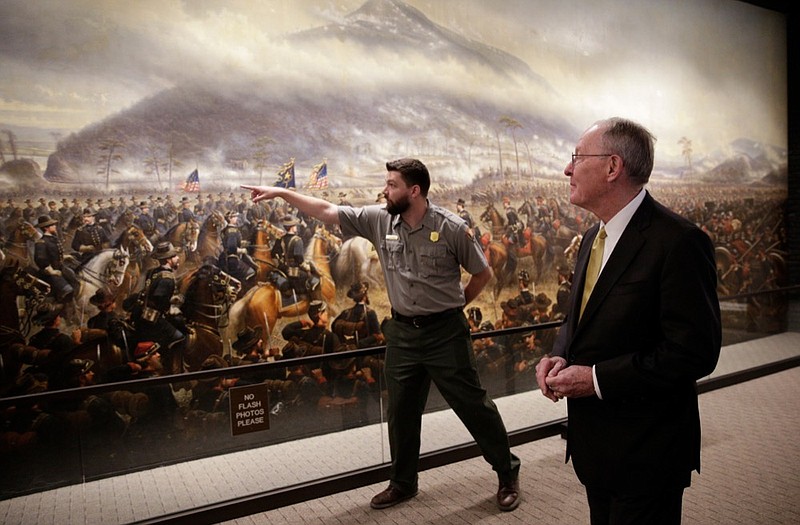 Park ranger Chris Barr, left, talks about "The Battle of Lookout Mountain" mural by James Walker with U.S. Sen. Lamar Alexander during a visit by Alexander to Point Park on Tuesday, April 3, 2018, in Lookout Mountain, Tenn. Sen. Alexander visited the park to push for a bill that he says will help address maintenance backlogs at federal parks like Point Park. / Staff photo by Doug Strickland

